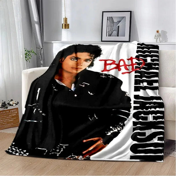 A black and white retro printed flannel throw blanket featuring a portrait of a person.