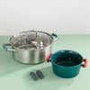 A stainless steel pot and a teal silicone pan handle cover are shown on a light green surface.