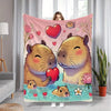 A plush flannel blanket featuring a cute cartoon print of two fluffy brown rabbits in pink and green floral surroundings.