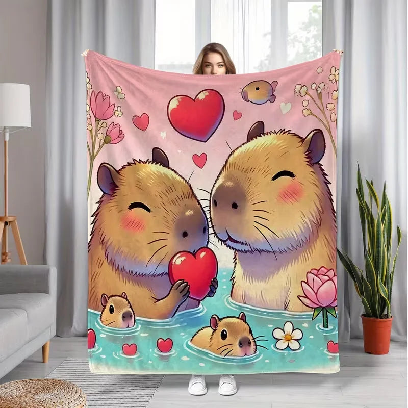 A plush flannel blanket featuring a cute cartoon print of two fluffy brown rabbits in pink and green floral surroundings.