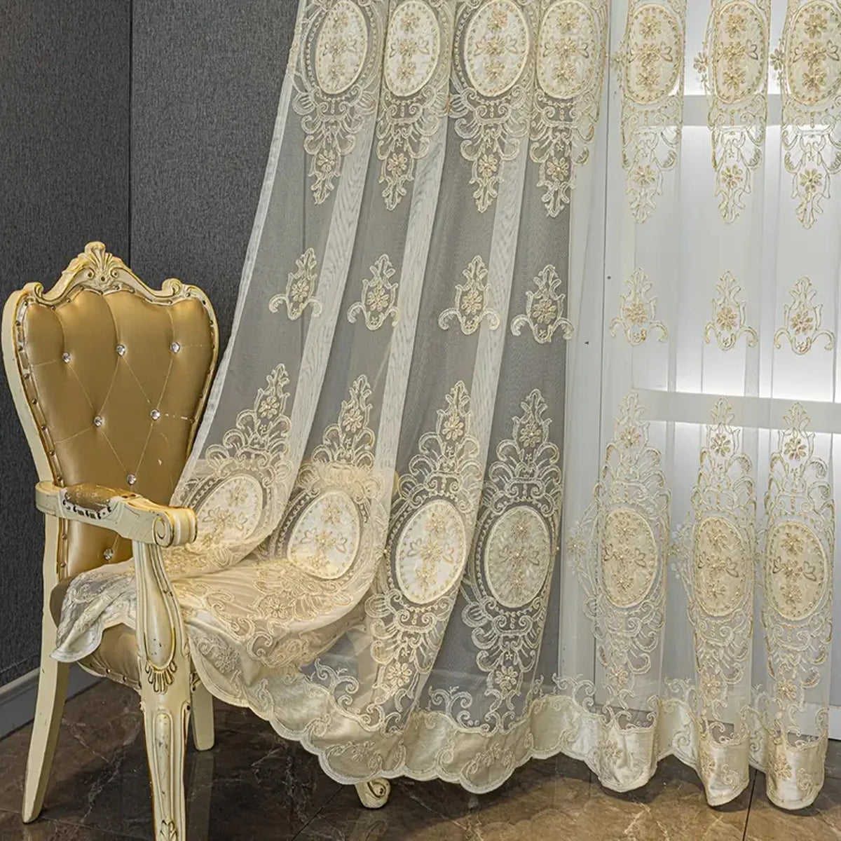 A sheer, embroidered beaded curtain with a punched-hole design hanging in a light setting.