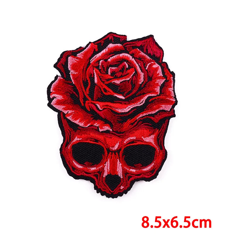 A red rose skull embroidery patch featuring a detailed floral design on a skull shape.