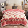 A pink floral weighted blanket displayed on a bed with white linens and wooden furniture.