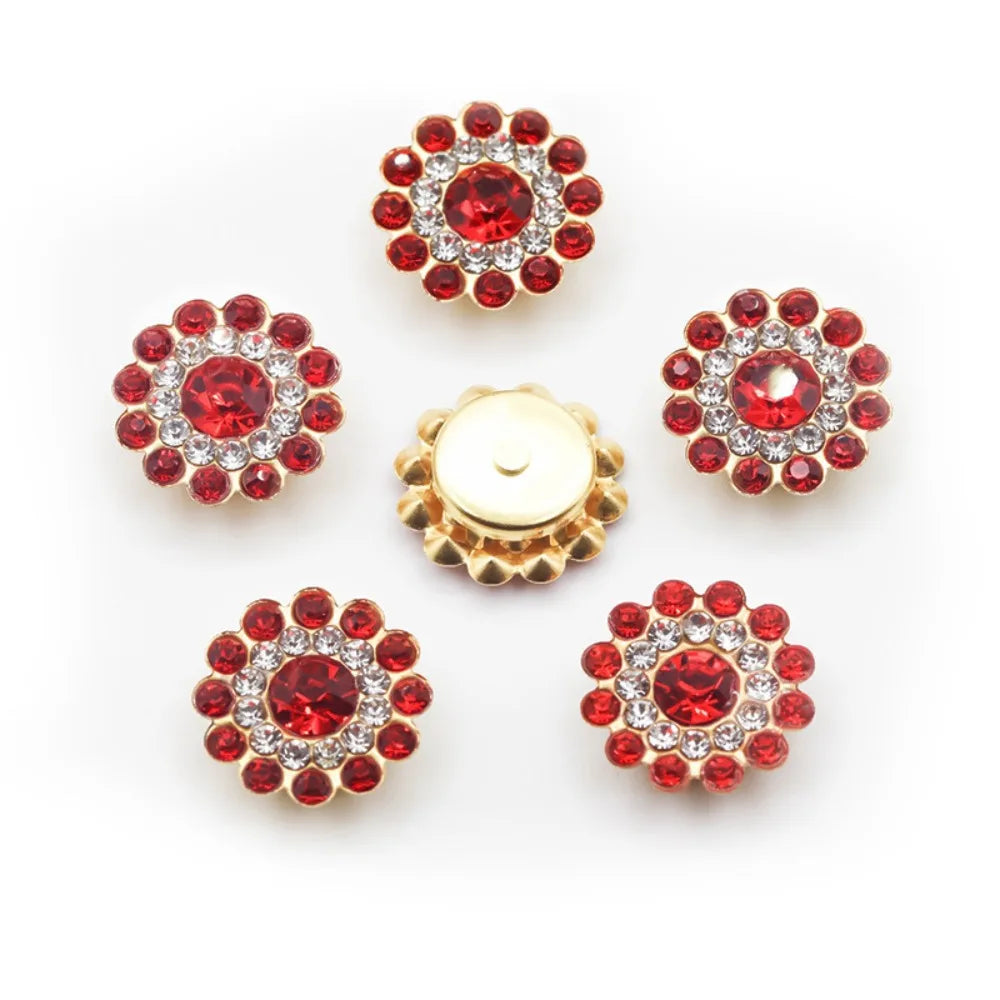A collection of six round, red and clear rhinestone crystals arranged in a starburst pattern.