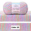 A ball of multicolored 4-ply cotton knit yarn with a gradient pattern resting on a knitted fabric background.