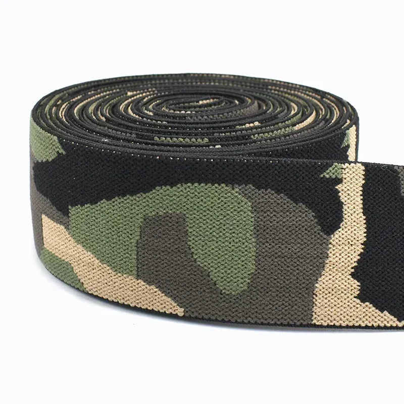 A roll of camouflage elastic stretch ribbon for sewing and craft projects in green, brown, and black patterns.