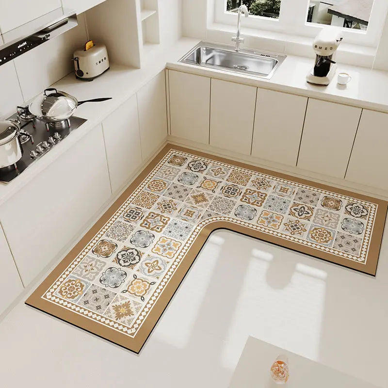 A luxury velvet anti-slip floor mat with a beige and gray geometric pattern placed on a white kitchen floor.