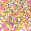 A pile of mixed clear glass and colored rhinestones for DIY crafts