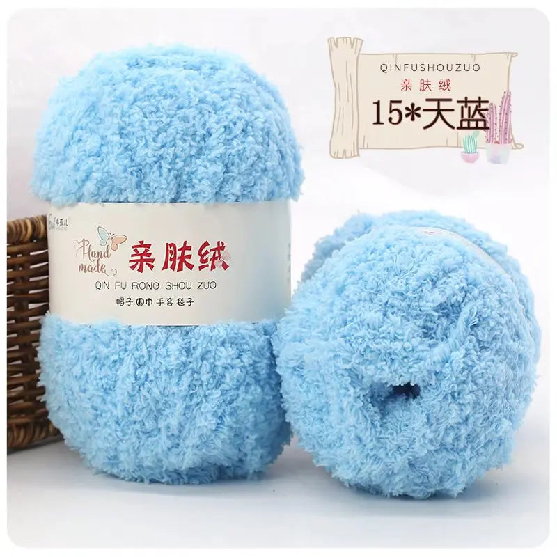 A ball of light blue fuzzy velvet yarn labeled as Soft Coral Velvet Yarn for Crafting
