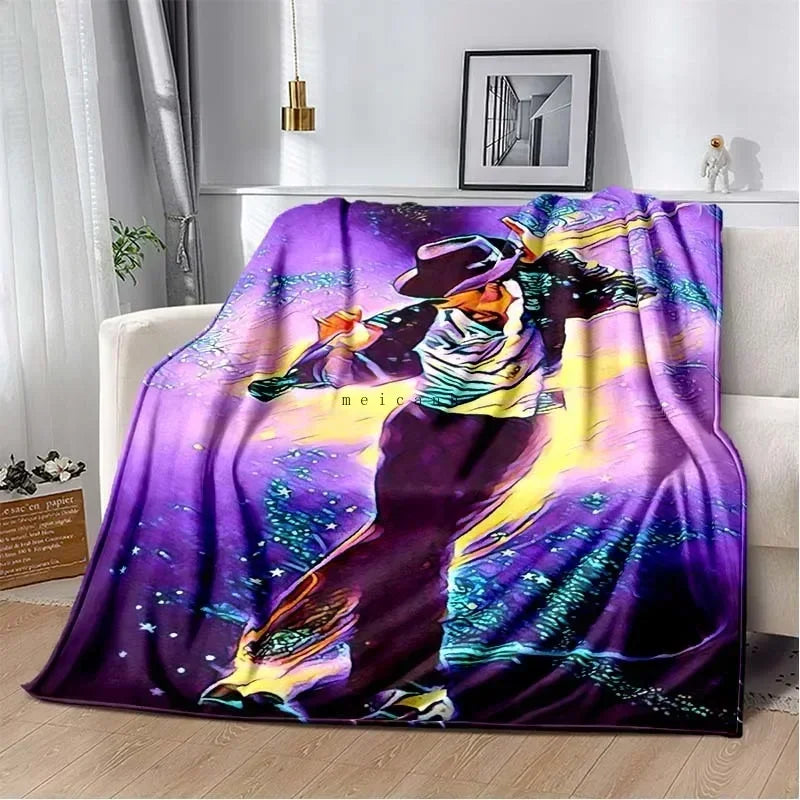 A purple and black printed flannel blanket featuring a stylized figure with bright yellow and green accents against a starry 