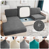 Close-up view of various splashproof jacquard sofa cushion covers in gray, cream, and teal colors.