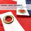 Close-up of a brass grommet used to secure a flag on a white fabric background.