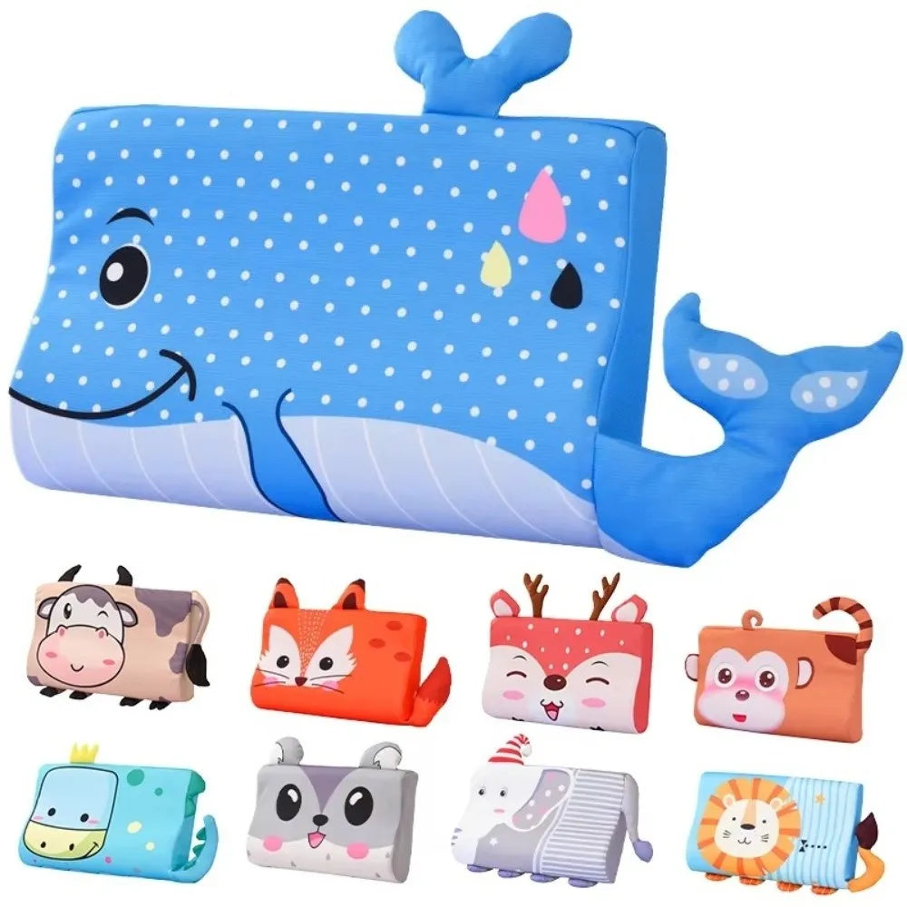 A blue ergonomic memory foam neck pillow shaped like a whale, surrounded by various silicone teething toys.
