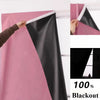 A close-up view of black and pink blackout curtains being installed on a window.