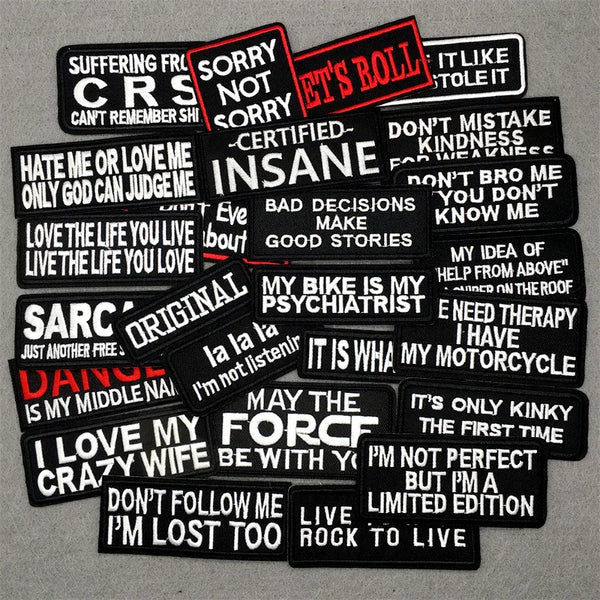 A collection of black iron-on embroidered patches featuring various text phrases like SORRY NOT SORRY IT'S A BOLL and I LOVE 