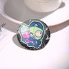 An enamel pin featuring an Invader ZIM anime character with a drink, set against a black background.