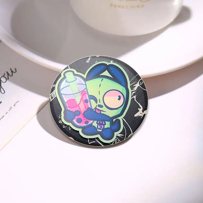 An enamel pin featuring an Invader ZIM anime character with a drink, set against a black background.