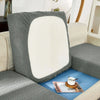 A gray jacquard sofa slipcover with elastic edges featuring a white cushion on a light-colored sofa.