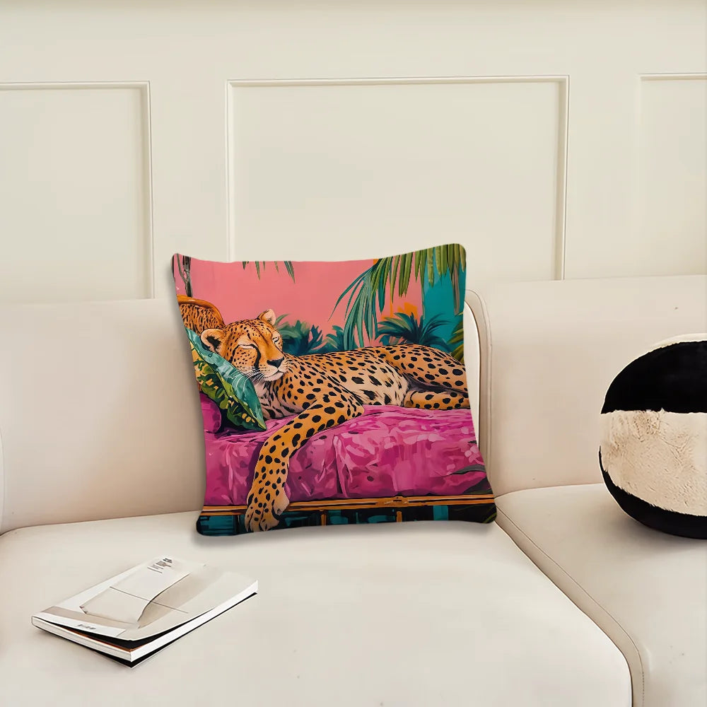 A pink and green cushion cover featuring a cheetah print and tropical plant design on a white sofa.