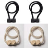 A set of four black magnetic curtain tiebacks and four beige magnetic curtain tiebacks.