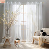 Semi-sheer white tulle curtains with floral texture hanging in a bright room.