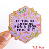 A purple embroidered patch shaped like a flower with green and pink leaves, featuring the text If you are looking for a sign 