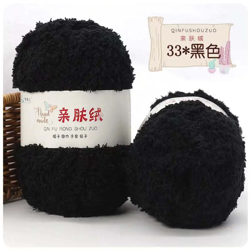 A black ball of soft coral velvet yarn is shown next to its label and a wooden stick.