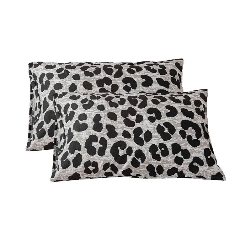 Two leopard print decorative pillow covers in gray and black spots.