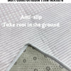 Close-up of a green area rug with a fine texture and thick edge wrapping