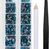 A clear plastic container holds various blue and silver crystal hot fix rhinestones and an applicator tool.