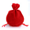 A single red velvet drawstring gift bag shaped like a gourd, with fringed ties.