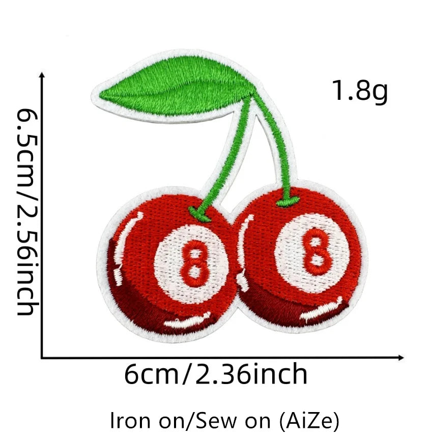 A pair of red embroidered fruit patches resembling cherries, measuring 1.8g and 6cm in diameter.