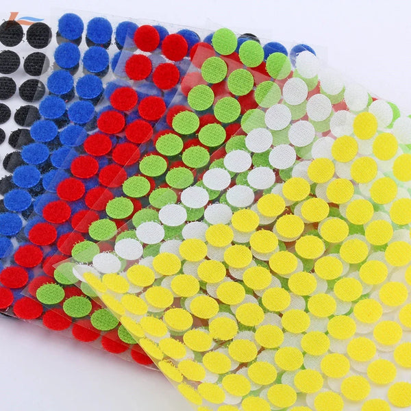 A close-up of multi-color self-adhesive hook and loop fastener tape in various shades of blue, red, green, white, and yellow.