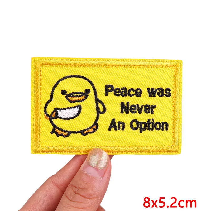 Yellow embroidered patch featuring a cartoon yellow duck with the text Peace was Never An Option