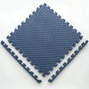 A blue interlocking foam play mat with a diamond pattern, shown from above.
