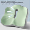 A light green ergonomic memory foam seat cushion is shown with arrows indicating air circulation under the buttocks.