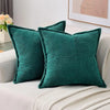 A set of deep teal striped corduroy lumbar support pillows resting on a light-colored fabric.