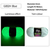 A spool of G002H Blue 100% Polyester yarn with a luminous effect, showing the bright green glow.