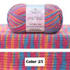 A skein of multi-colored yarn featuring pink, blue, and yellow stripes displayed on a textured pink knit background.
