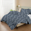 A gray botanical print duvet cover set featuring leafy patterns on a bed.