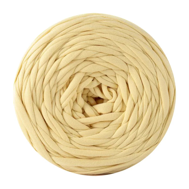 A ball of light beige soft T-shirt yarn used for crochet