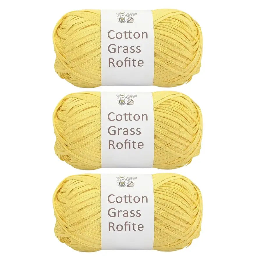 Three skeins of yellow cotton grass roving yarn displayed side by side.
