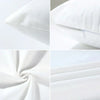 Close-up view of a white pillow cover with geometric green and gold accents, showing fabric texture and stitching.