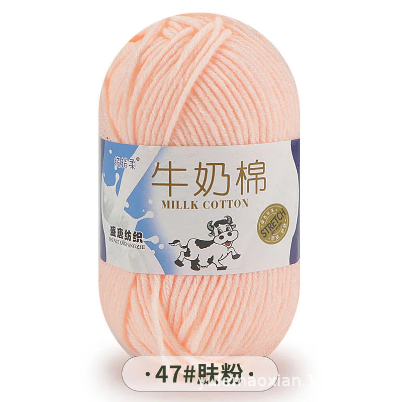A ball of pink milk cotton yarn labeled in Chinese and English for knitting