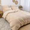 A beige bohemian grid tufted duvet cover set displayed on a bed with matching pillows and natural light.
