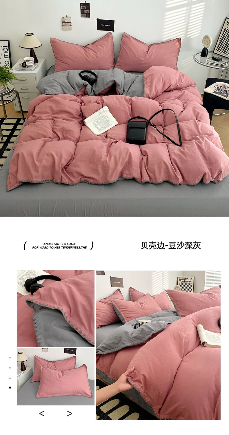 A pink and gray luxurious bed linen set featuring a duvet, pillows, and sheets.