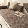 A textured gray plush sofa cushion cover with a diamond pattern and a cream accent pillow.