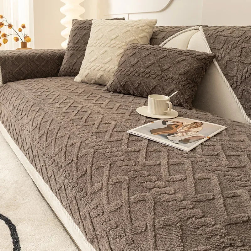 A textured gray plush sofa cushion cover with a diamond pattern and a cream accent pillow.