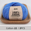 A ball of bright blue 100% organic cotton yarn labeled QJH for knitting and crochet