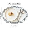 A white placemat is shown with a plate, a knife, and a spoon, demonstrating the size of the placemat.